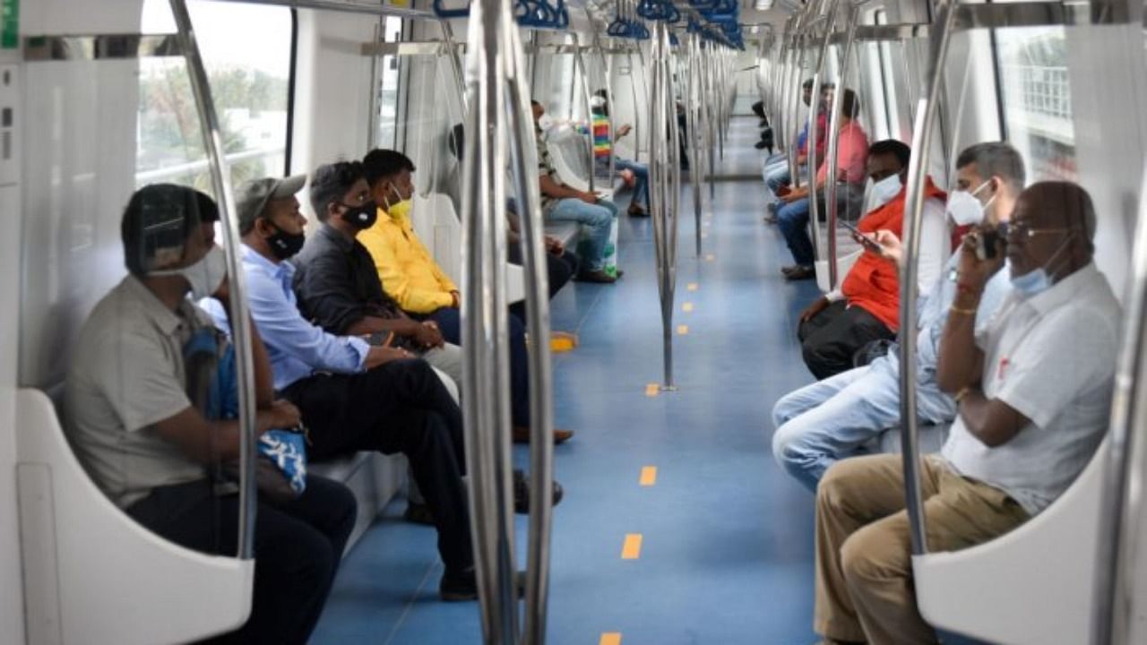 Passengers take the metro train on Monday, the day the Mysuru Road-Kengeri line was opened to the public. Credit: DH Photo