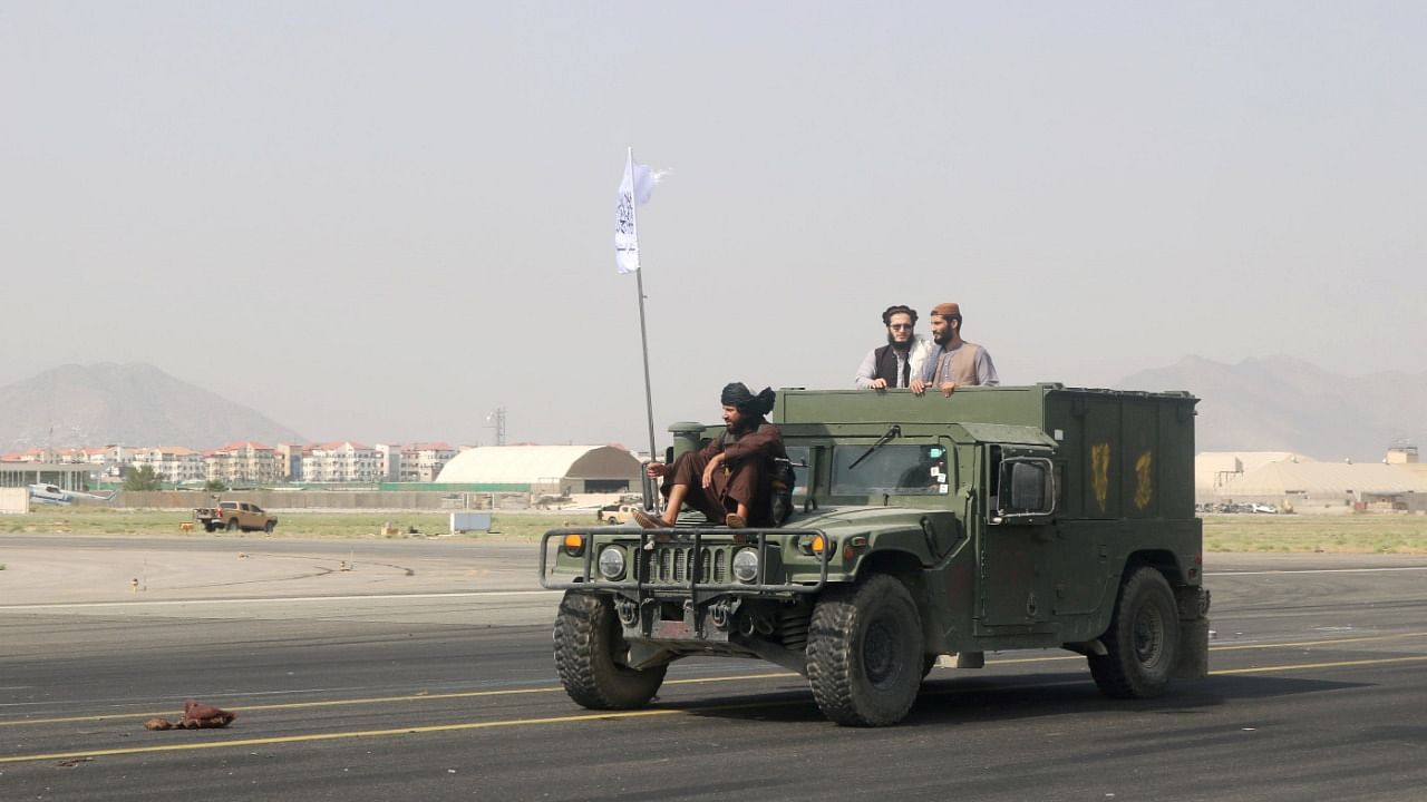 Taliban forces patrol at a runway. Credit: Reuters Photo