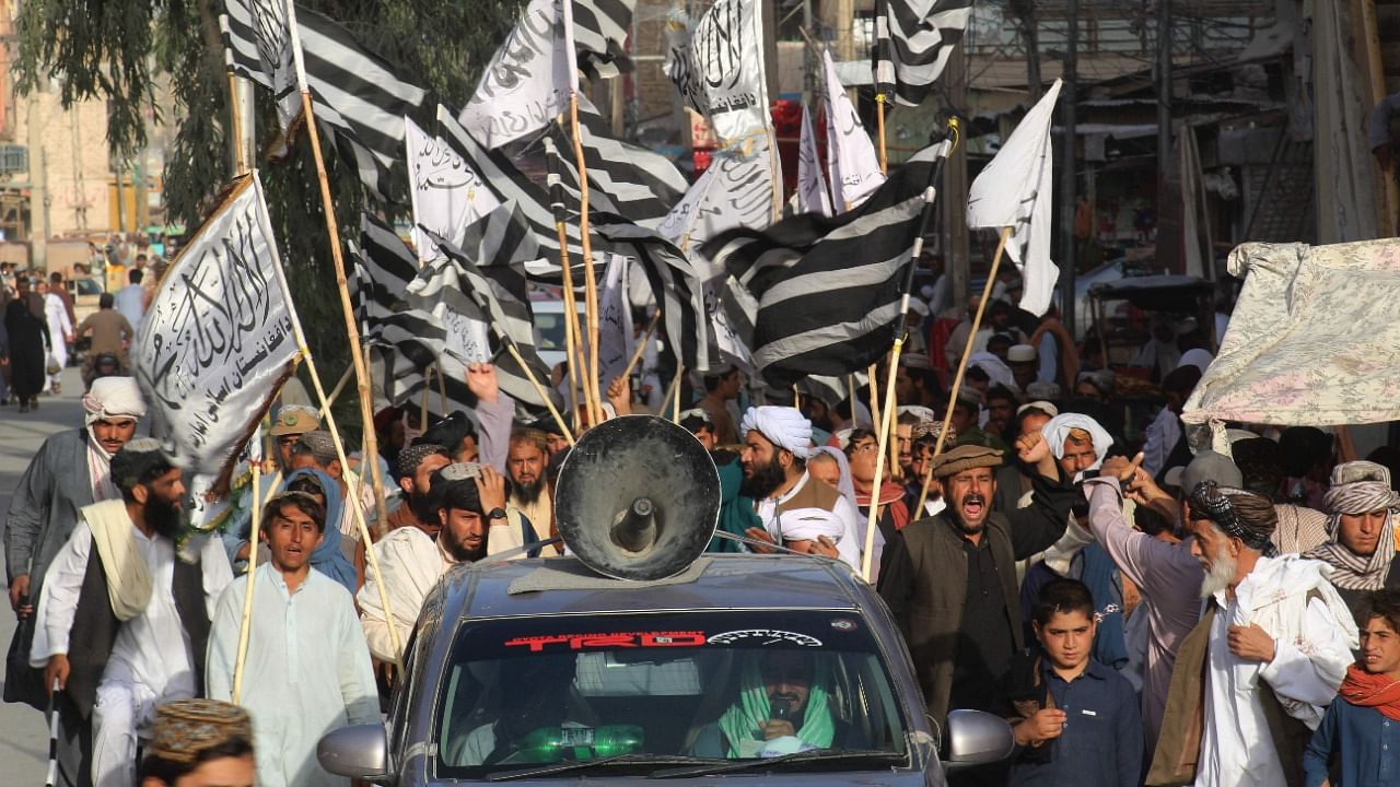 People wave Taliban flags and shout slogans during a rally in Chaman, a town at the Pakistan-Afghanistan border, on August 31, 2021, after the US pulled all its troops out of the country to end a brutal 20-year war -- one that started and ended with the hardline Islamist in power. Credit: AFP Photo