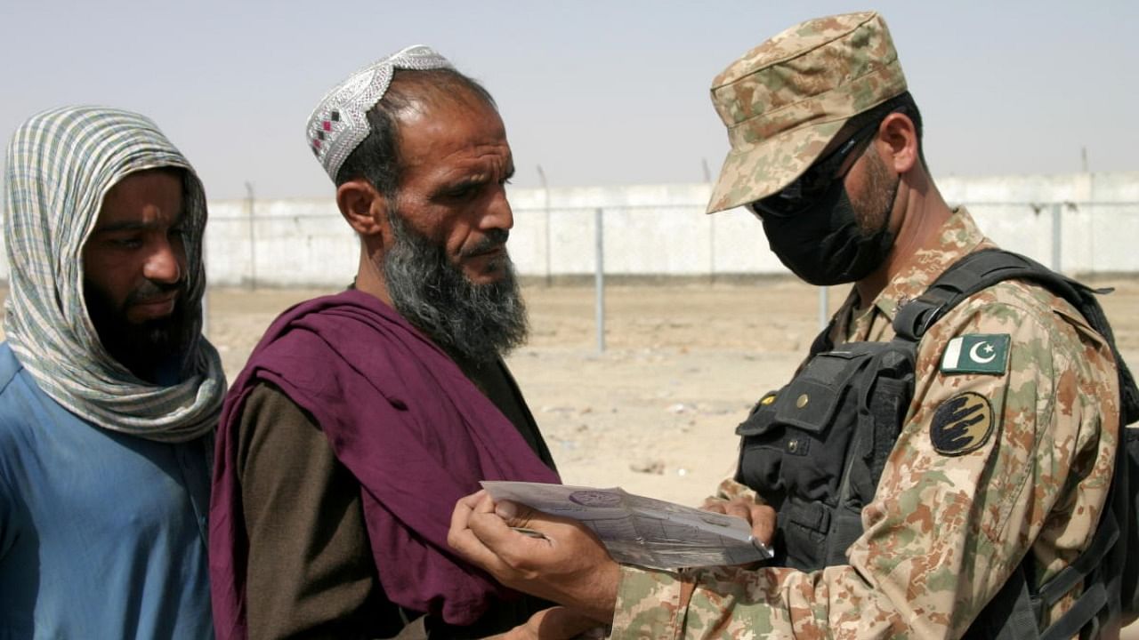 A Pakistani soldier checks documents of people arriving from Afghanistan at the Friendship Gate crossing point in the Pakistan-Afghanistan border town of Chaman. Credit: Reuters file photo