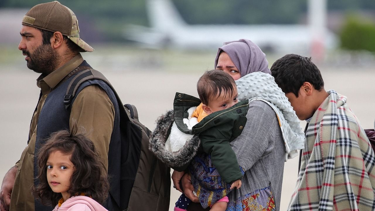 Afghan evacuees get in a plane to the United States at the US Air Base Ramstein. Credit: AFP File Photo