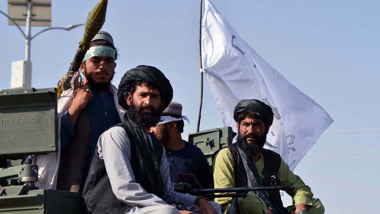 Taliban fighters stand on an armoured vehicle parade along a road to celebrate after the US pulled all its troops out of Afghanistan, in Kandahar on September 1, 2021 following the Taliban’s military takeover of the country. Credit: AFP Photo