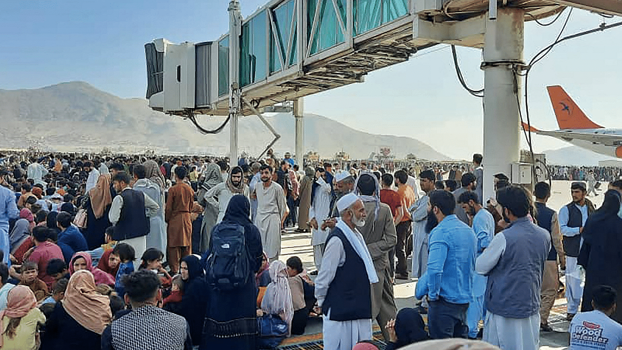 Afghans crowd at the tarmac of the Kabul airport. Credit: AFP Photo/Representative image