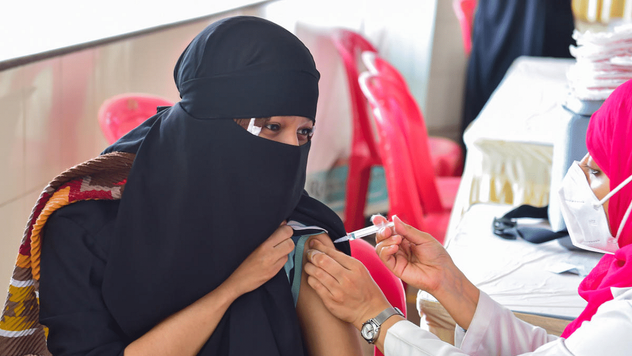 A beneficiary receives a dose of Covid-19 vaccine, at a special vaccination drive "Vaccination Mela", in Bengaluru. Credit: PTI Photo