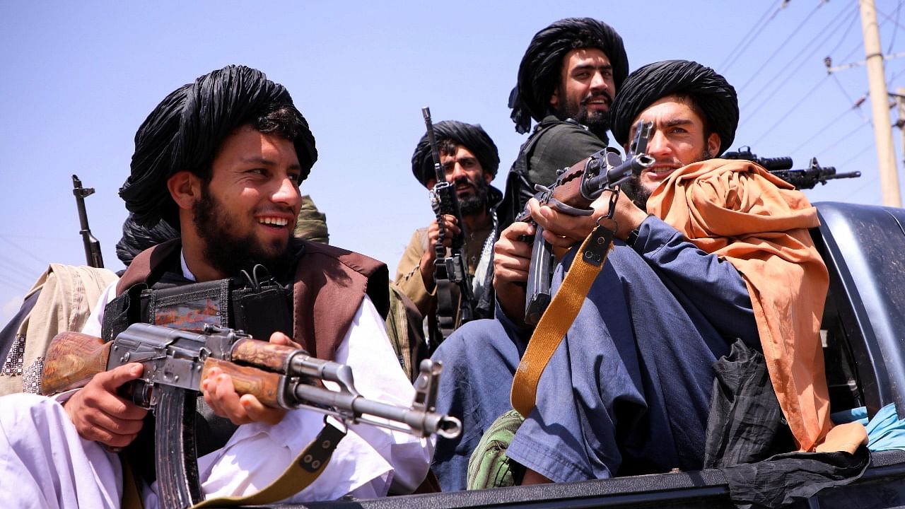 Taliban forces patrol in front of Hamid Karzai International Airport in Kabul. Credit: Reuters Photo