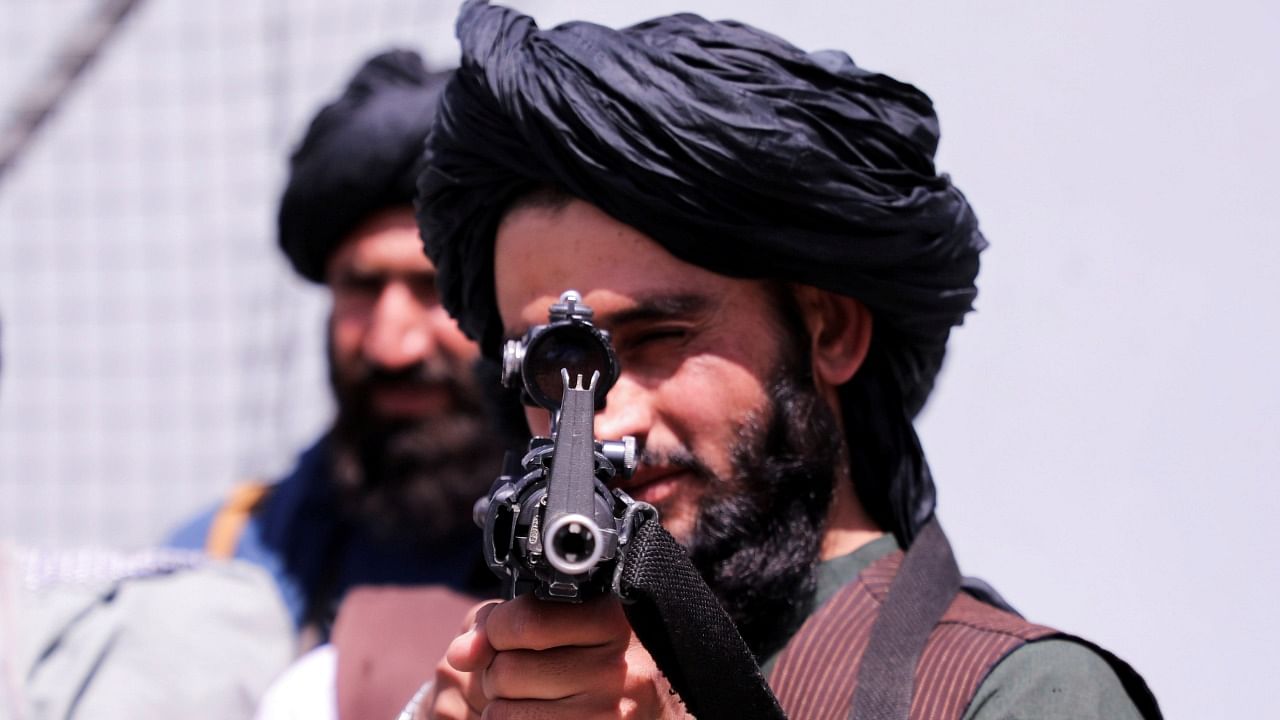 Taliban forces stand guard in front of Hamid Karzai International Airport in Kabul. Credit: Reuters Photo