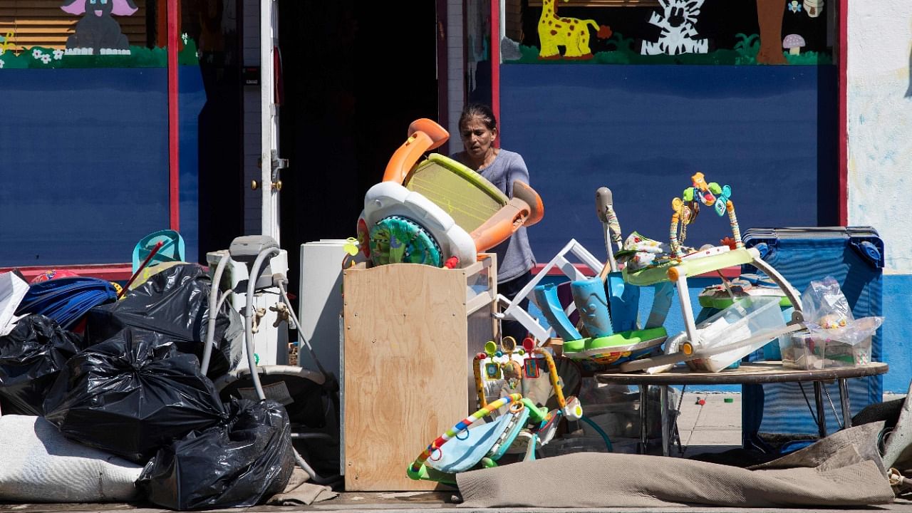 A woman removes furnitures from a daycare following a night of heavy wind and rain from the remnants of Hurricane Ida on September 02, 2021 in in Mamaroneck, New York. Credit: AFP Photo