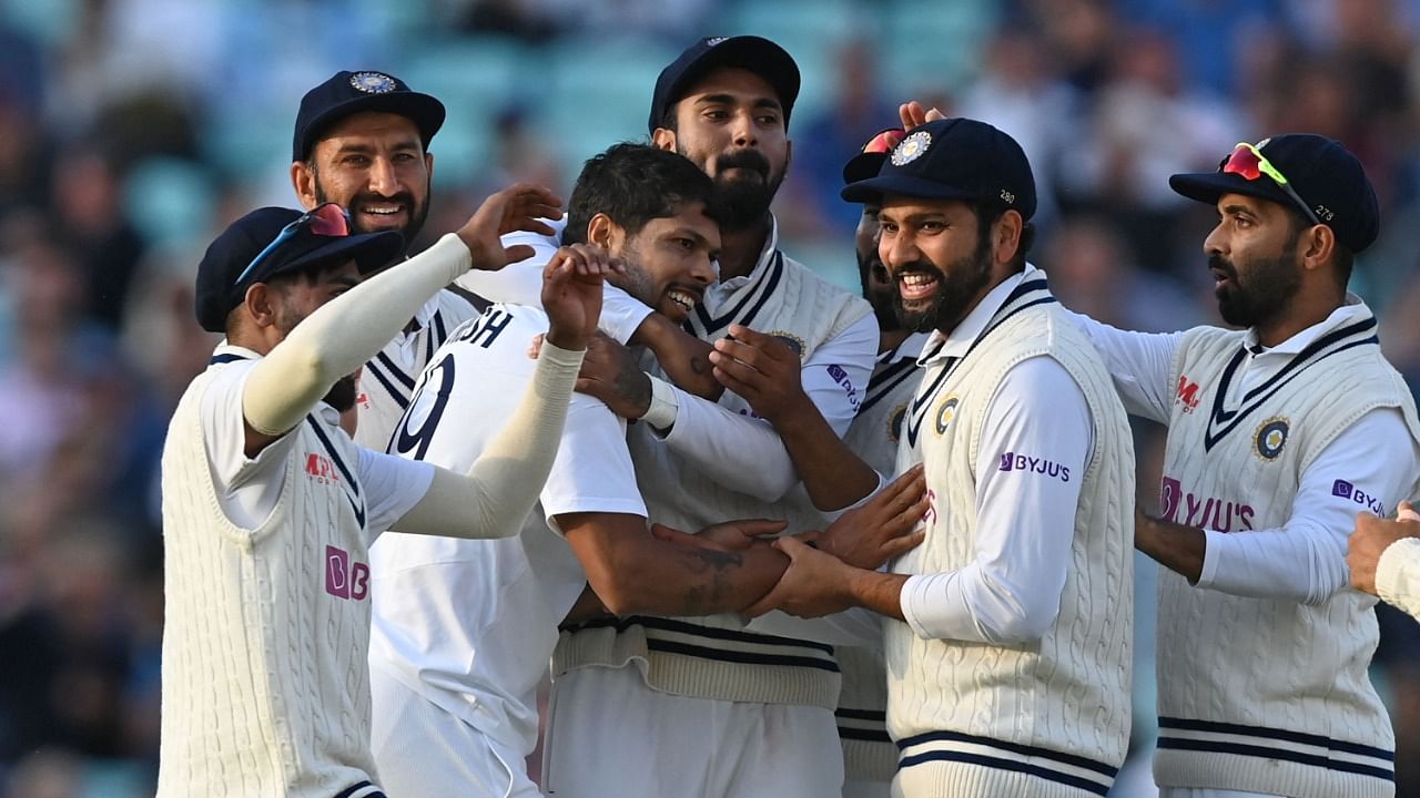 India's Umesh Yadav (C) celebrates with teammates after bowling England's captain Joe Root for 21 runs during play on the first day of the fourth cricket Test match between England and India at the Oval cricket ground in London on September 2, 2021. Credit: AFP Photo