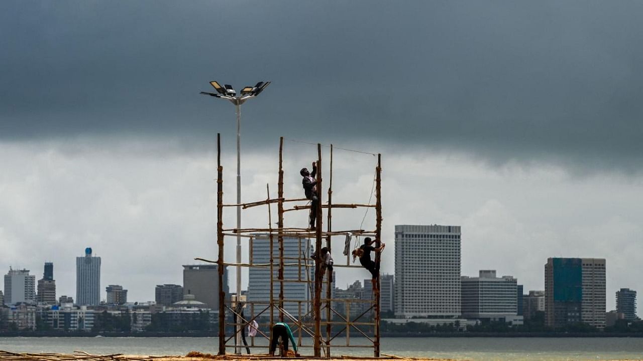 Workers install a temporary structure at a beachfront in preparations for the upcoming Ganesh Chaturthi festival in Mumbai. Credit: AFP Photo