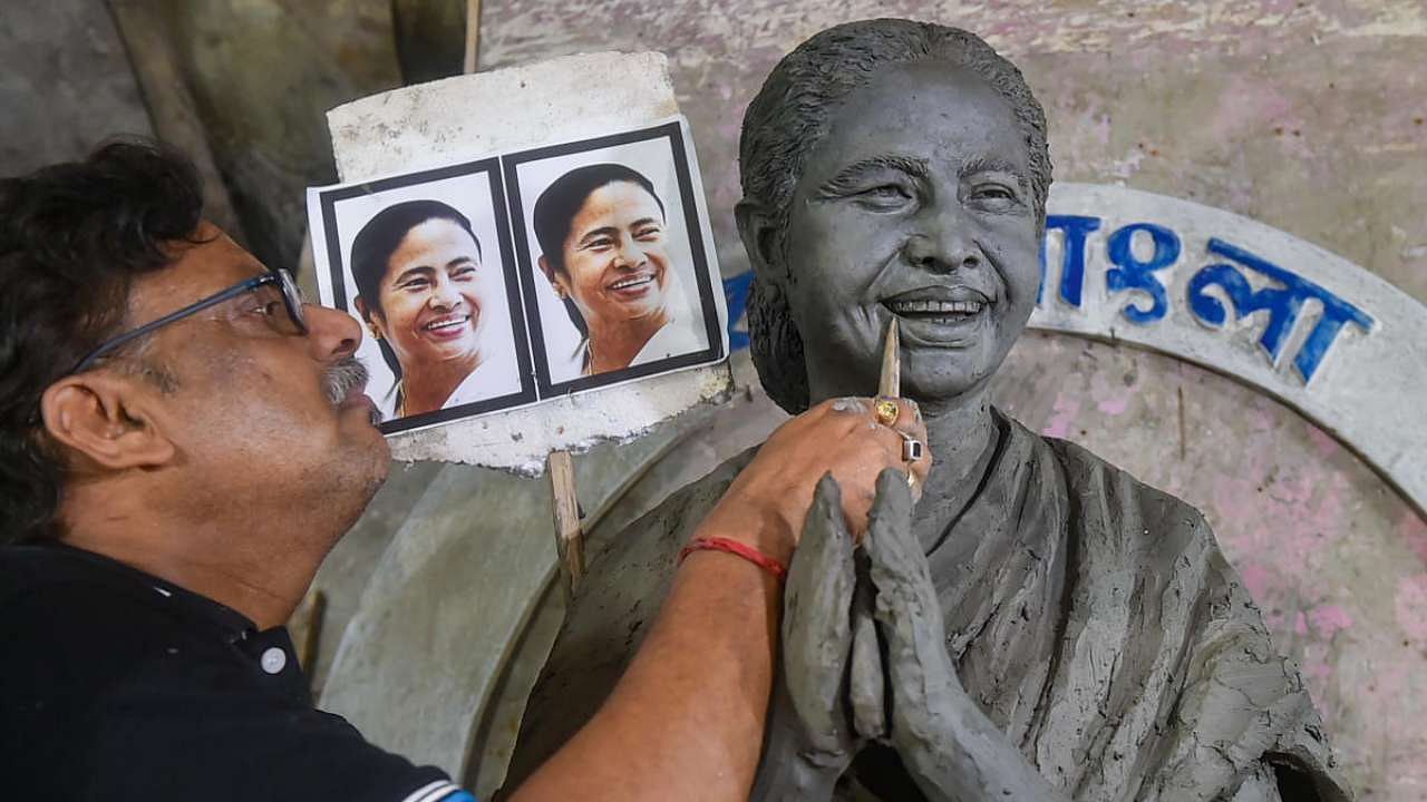 Artist Mintu Paul prepares a clay idol of West Bengal Chief Minister Mamata Banerjee at Kumartuli artisan village, in Kolkata. Credit: PTI Photo