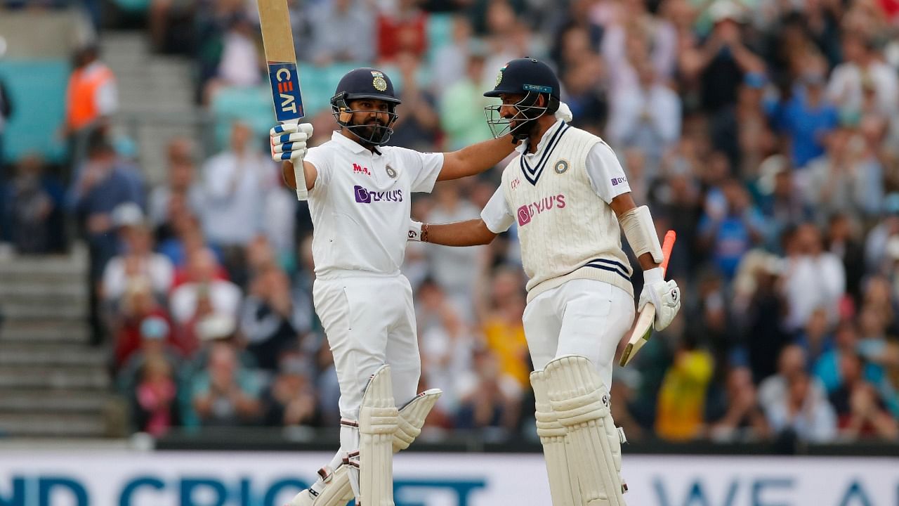 Rohit Sharma (L) celebrates his century against England on Day 3 of the 4th Test along with Cheteshwar Pujara. Credit: Reuters Photo