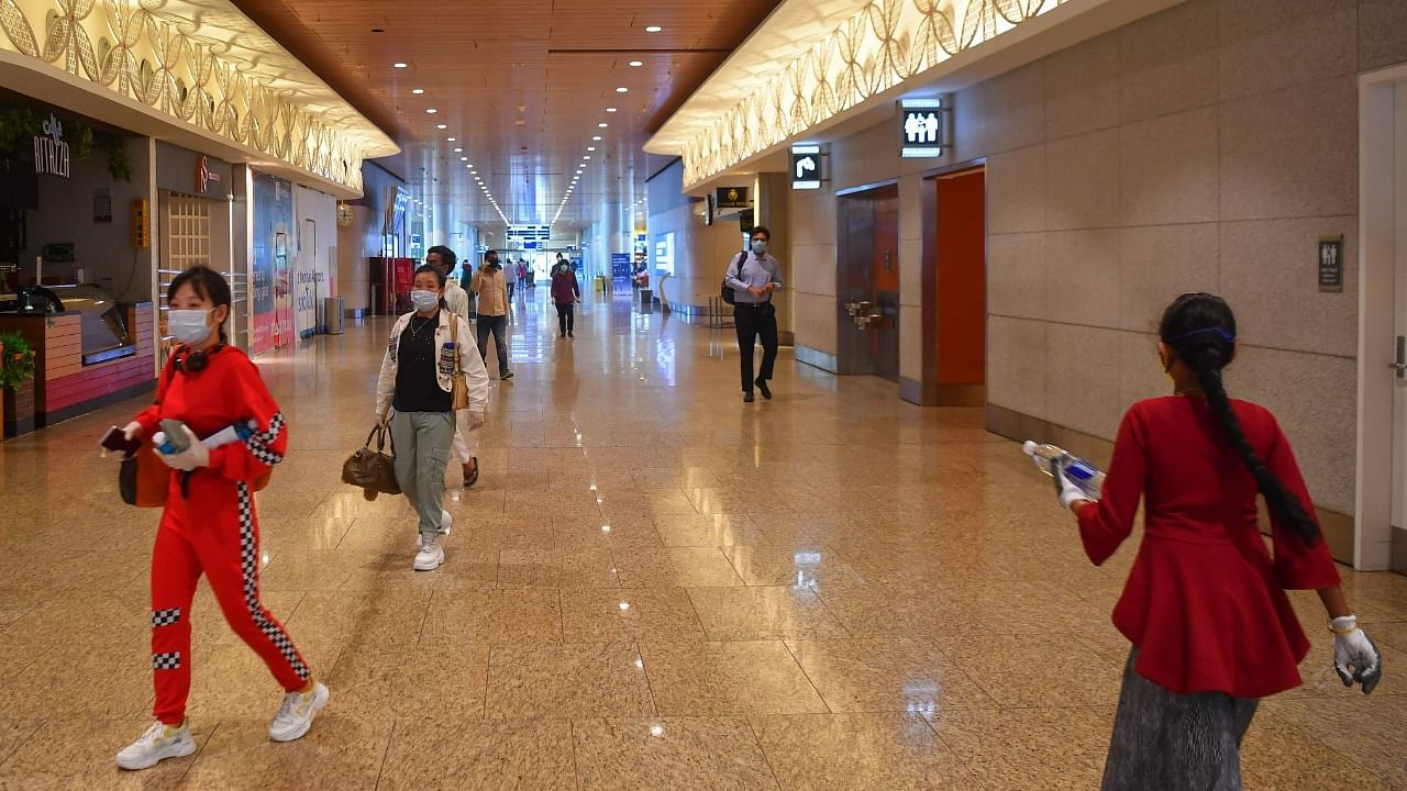 Travellers walk to their boarding gates in the Chhatrapati Shivaji Maharaj International Airport. Credit: AFP Photo