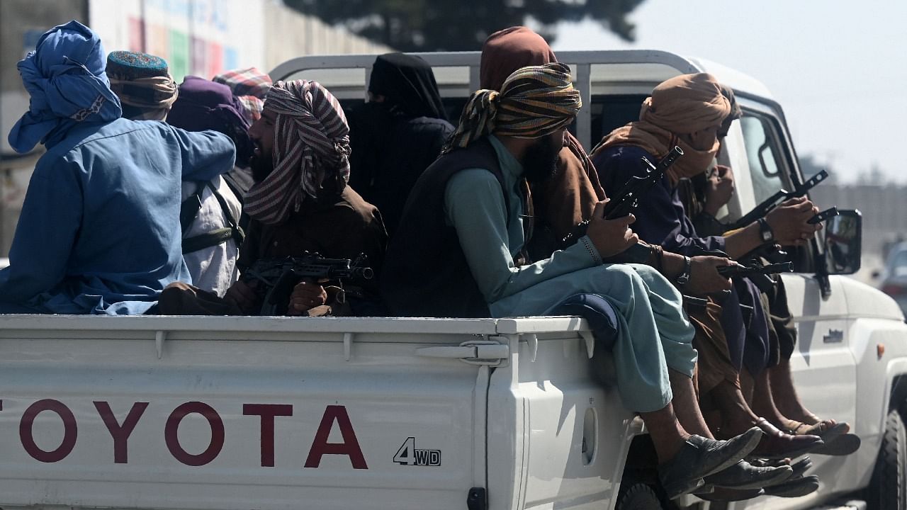 Taliban fighters patrol on a vehicle outside Kabul International Airport. Credit: AFP Photo