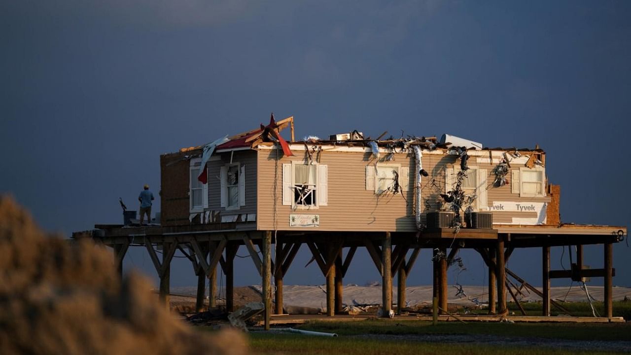 The sun sets on a storm-damaged house in the wake of Hurricane Ida on September 3, 2021 in Grand Isle, Louisiana. Credit: AFP Photo