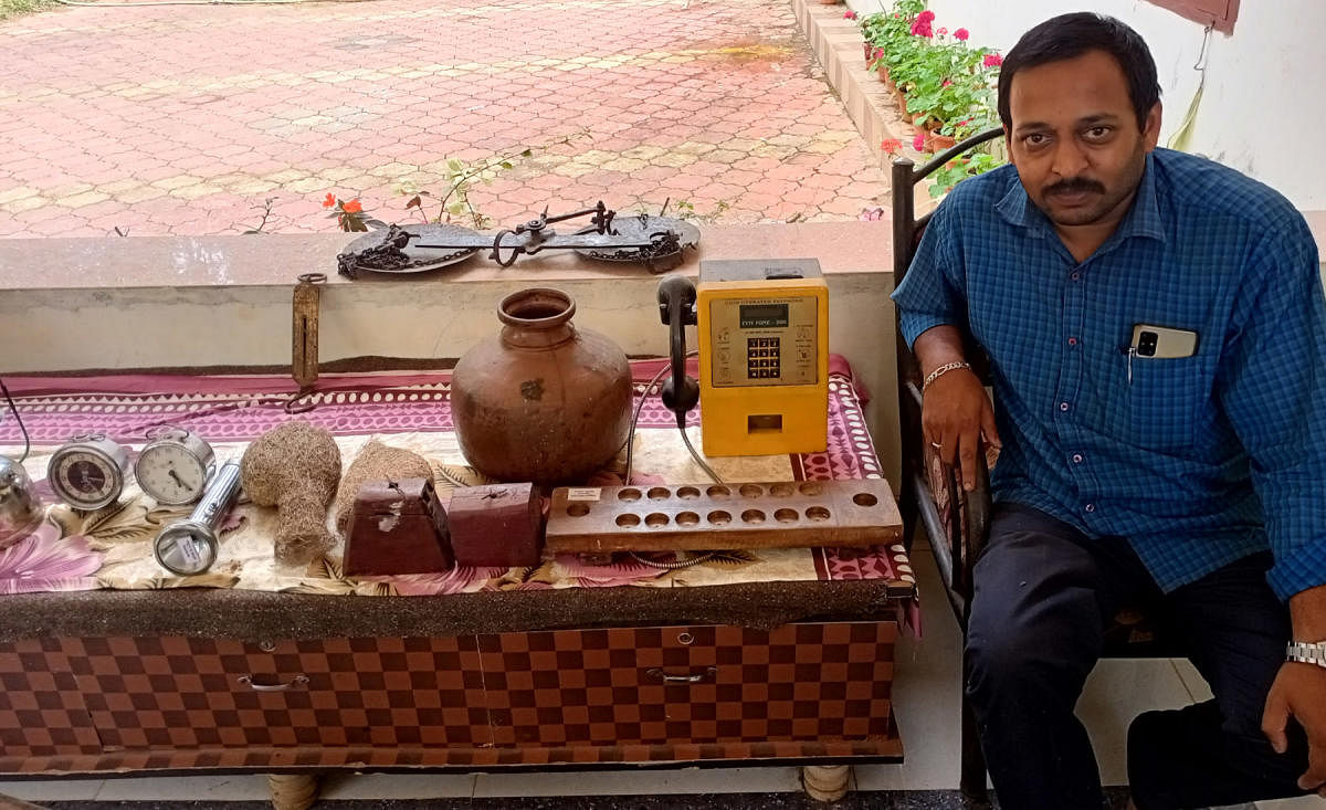 Harish with his antique collection at his house in Kiggalu.