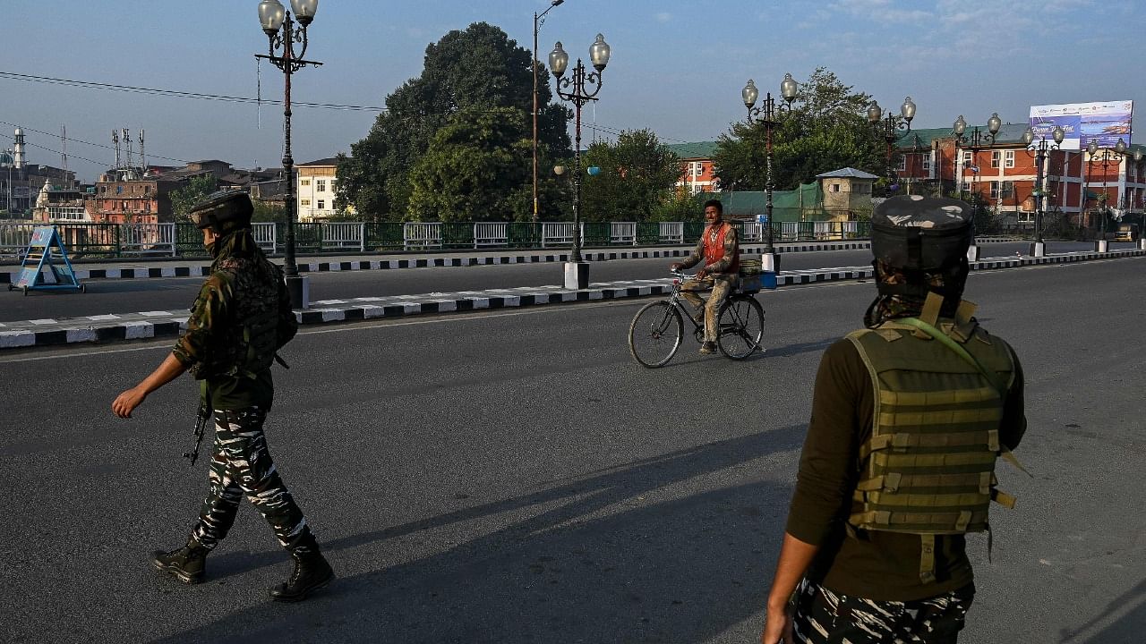 Indian paramilitary troopers patrol along a road in Srinagar. Credit: AFP Photo