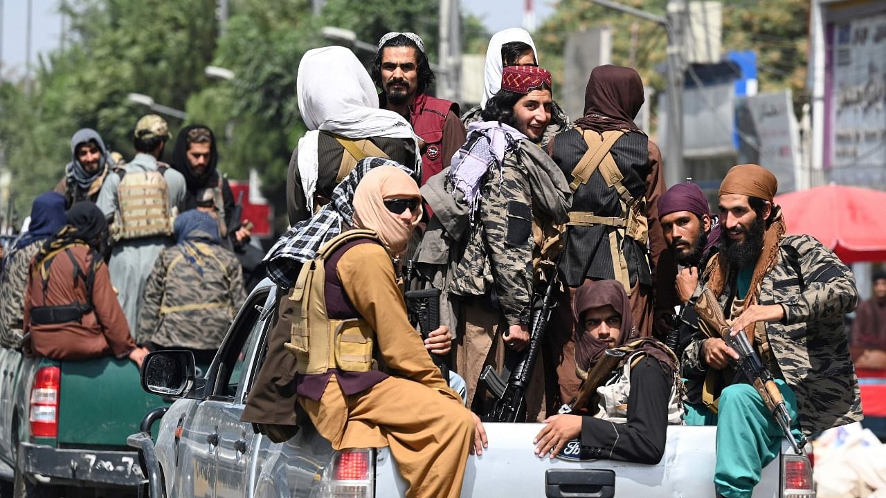 Taliban fighters patrol on vehicles. Credit: AFP Photo