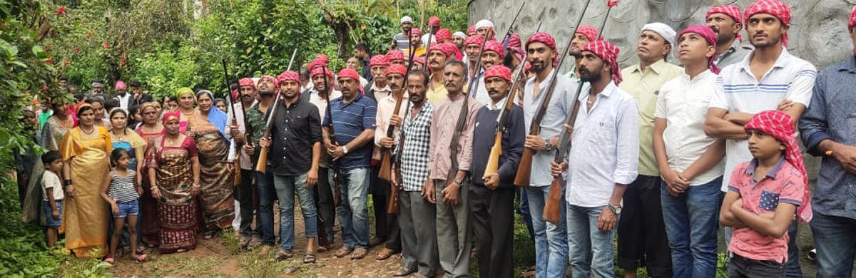 Villagers get ready to take part in a coconut shooting competition as a part of 'Kail Pold' festival held in Nadikeri near Gonikoppa.