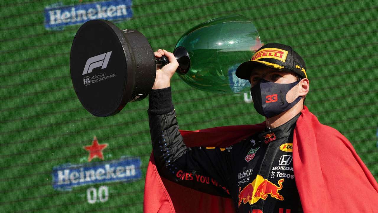 Red Bull's Max Verstappen celebrates on the podium with the trophy after winning the race. Credit: Reuters Photo