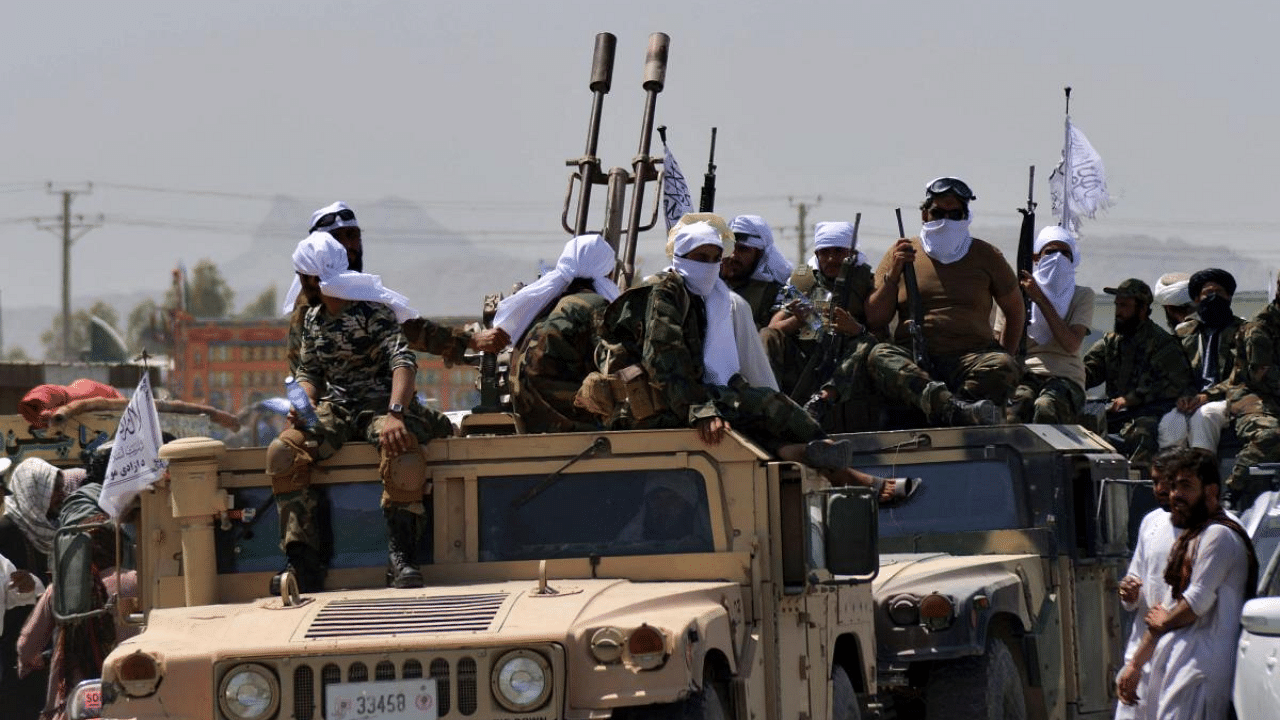 Taliban fighters atop Humvee vehicles parade along a road to celebrate after the US pulled all its troops out of Afghanistan, in Kandahar. Credit: AFP File Photo