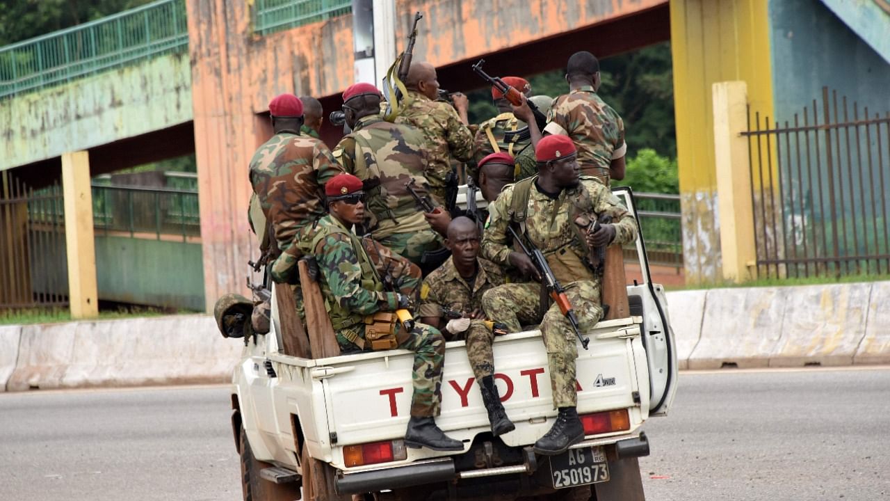 Members of the Armed Forces of Guinea drive through the central neighbourhood of Kaloum in Conakry. Credit: AFP Photo