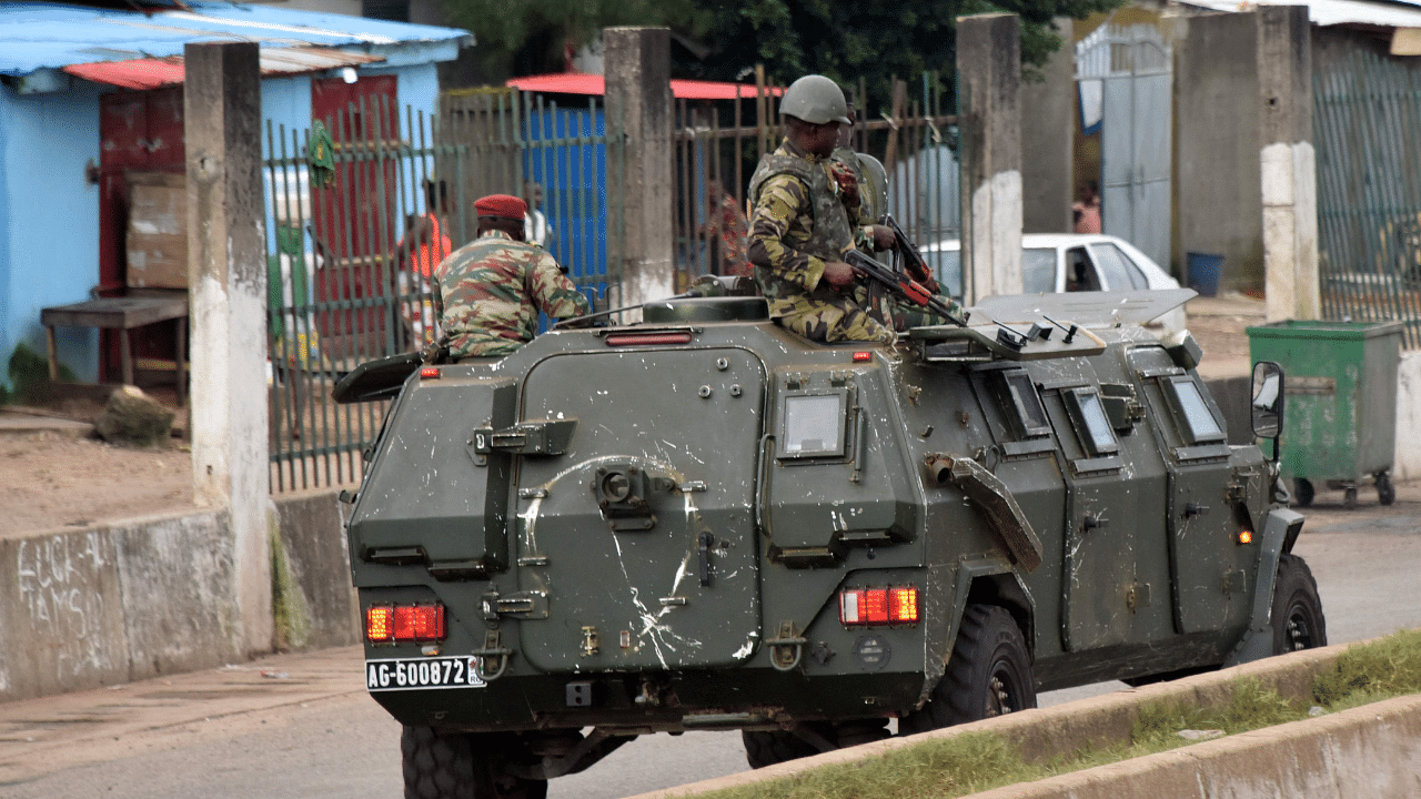 Members of the Armed Forces of Guinea drive through the central neighbourhood of Kaloum in Conakry. Credit: AFP Photo