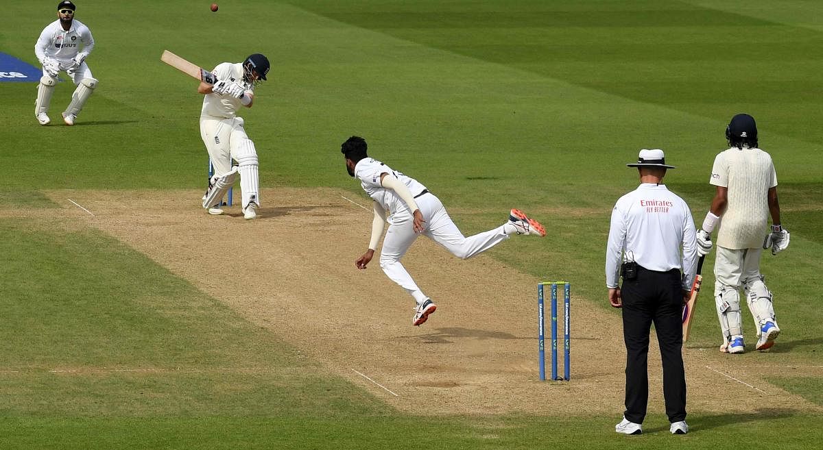 Joe Root (2L) ducks a high ball bowled by India's Mohammed Siraj (C) during play on the fifth day of the fourth cricket Test match between England and India at the Oval cricket ground in London. Credit: AFP Photo