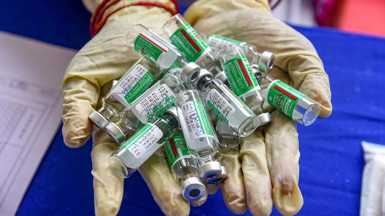 A health worker shows empty vials of Covishield vaccine at a vaccination centre. Credit: PTI Photo