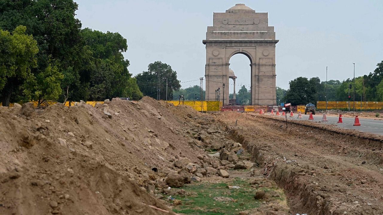 The site of a redevelopment work of the Central Vista Avenue by Central Public Works Department (CPWD) along the Rajpath road is pictured in front of the India Gate in New Delhi on May 9, 2021. Credit: AFP File Photo