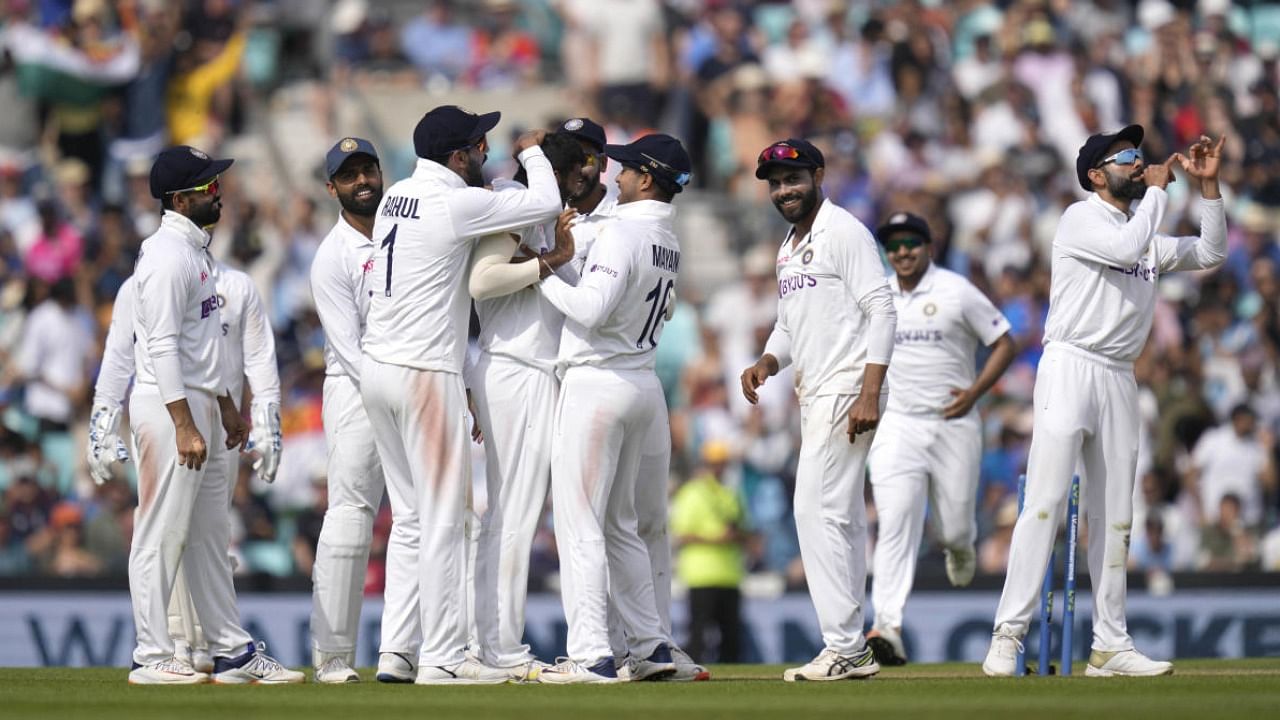 India players celebrate taking the wicket of England's Jonny Bairstow on day five of the fourth Test match at The Oval cricket ground in London. Credit: AP Photo