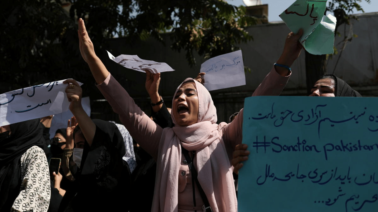 A woman raises her hands as she chants during the anti-Pakistan protest in Kabul, Afghanistan. Credit: Reuters Photo