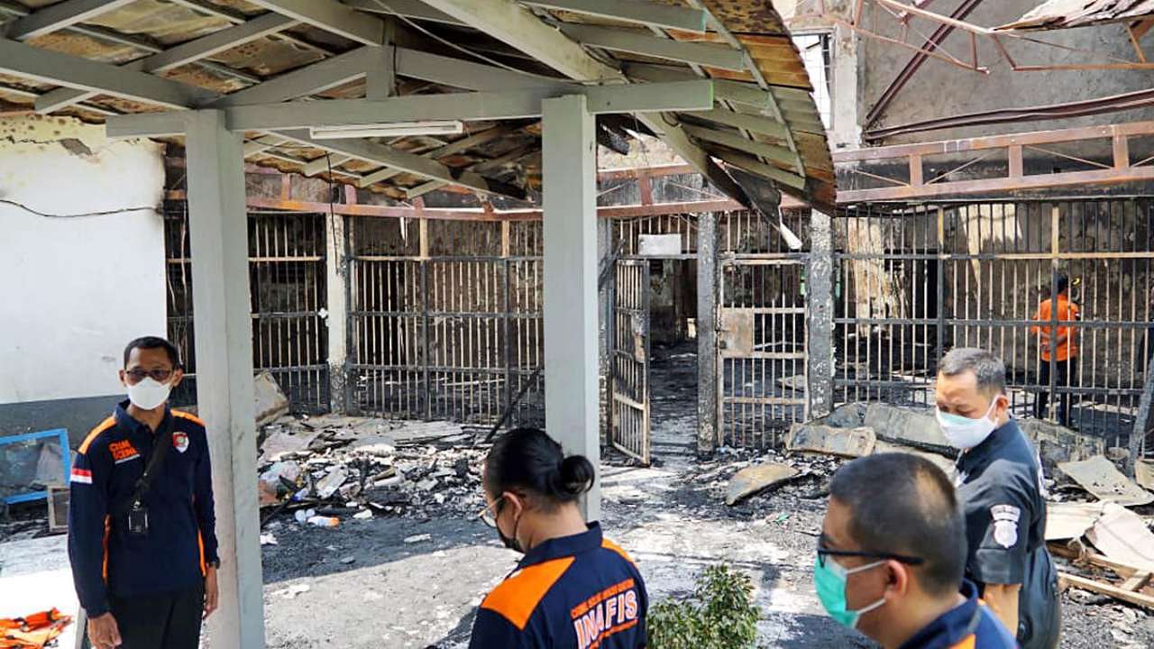 In this photo released by the Indonesian Ministry of Justice and Human Rights, police officers inspect damage cells after a fire at Tangerang Prison in Tangerang, Indonesia. Credit: AP Photo