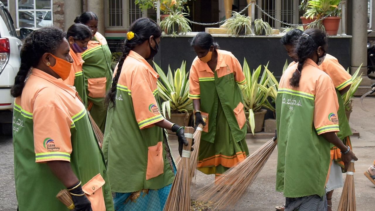 BBMP Pourakarmika's seen cleaning an area in Bengaluru. Credit: DH file photo