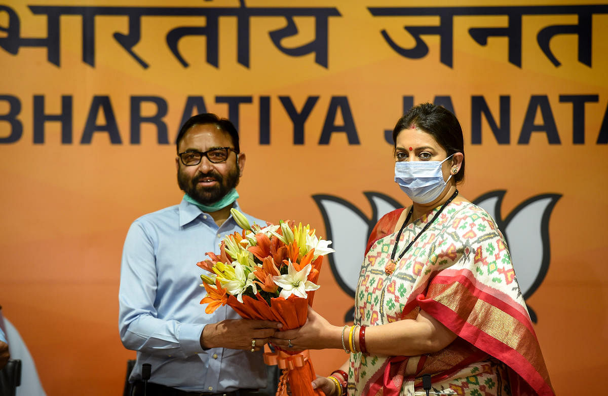 Independent MLA from Dhanolti (Uttarakhand) Pritam Singh Panwar joins BJP in presence of Union Minister and party leader Smriti Irani at party headquarters in New Delhi. Credit: PTI Photo