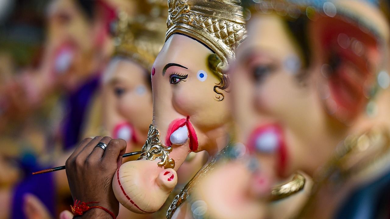 An artist gives final touches to a clay idol of Lord Ganesh ahead of the Ganesh Chaturthi festival, at his workshop in Mumbai. Credit: PTI photo