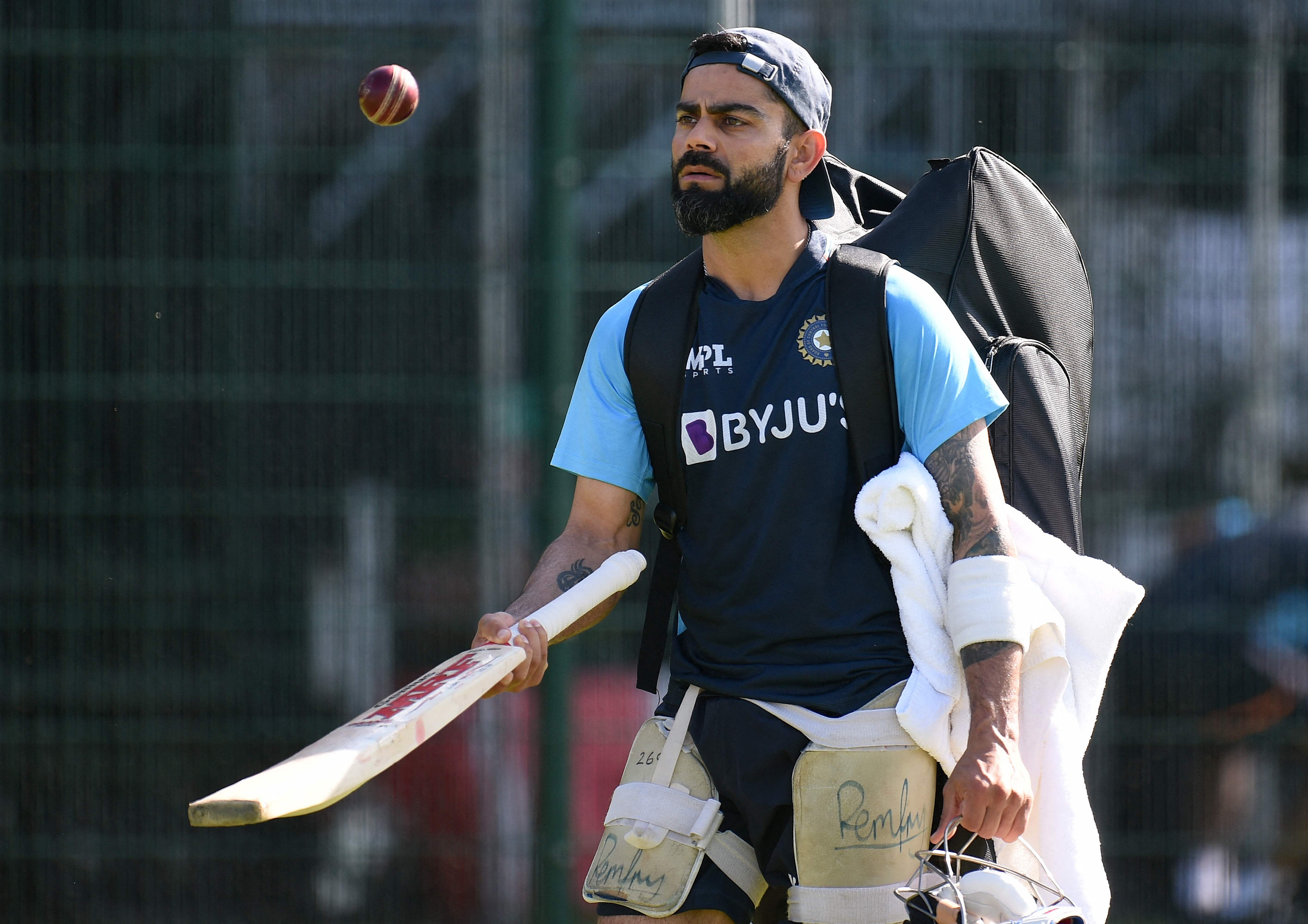 India's captain Virat Kohli bounces a ball on a cricket bat during a team practice session ahead of the fifth cricket Test match between England and India at Old Trafford in Manchester. Credit: AFP Photo