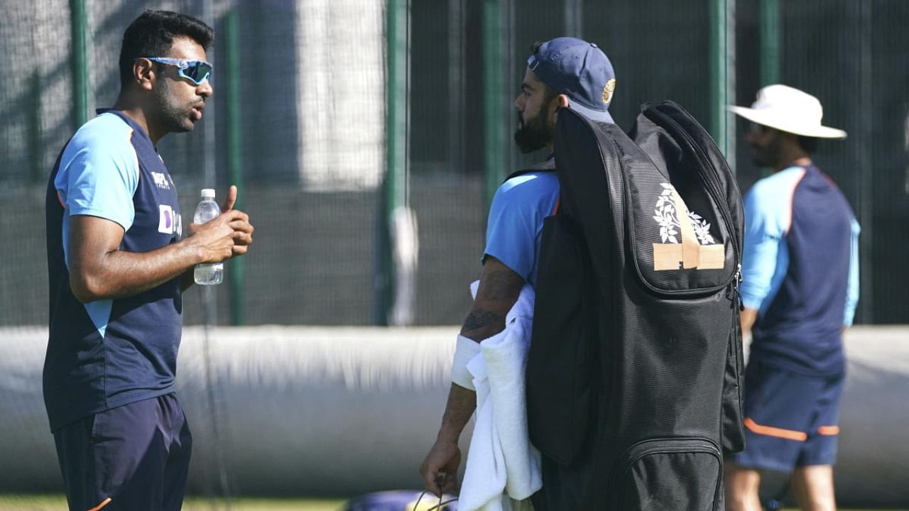 India's Ravichandran Ashwin, left, and Virat Kohli chat during the nets session at Old Trafford. Credit: AP/PTI photo