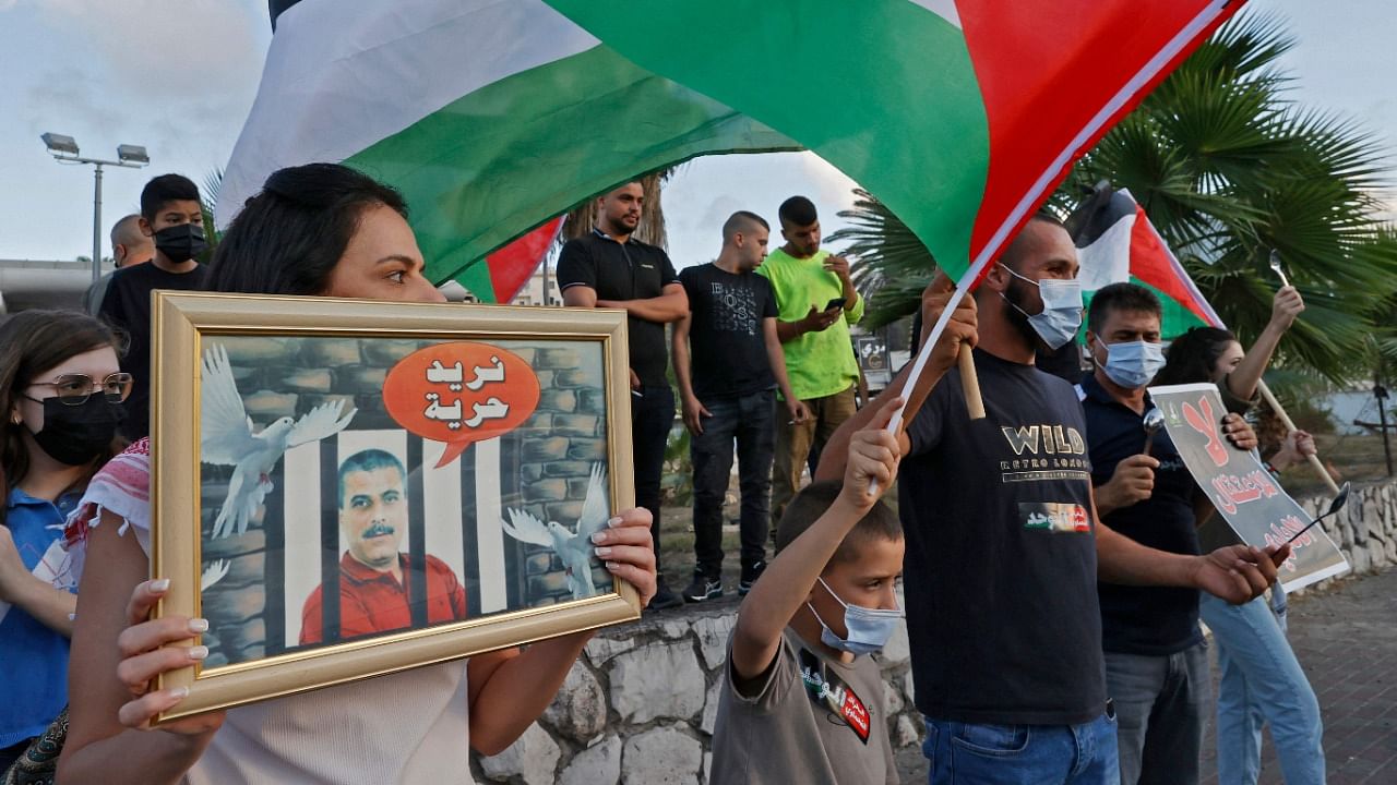 Arab Israeli protesters demonstrate in the mostly Arab city of Umm al-Fahm in northern Israel, to denounce punitive measures taken by the Israel Prison Service against Palestinian prisoners, after six of them escaped from the northern Gilboa prison. Credit: AFP Photo