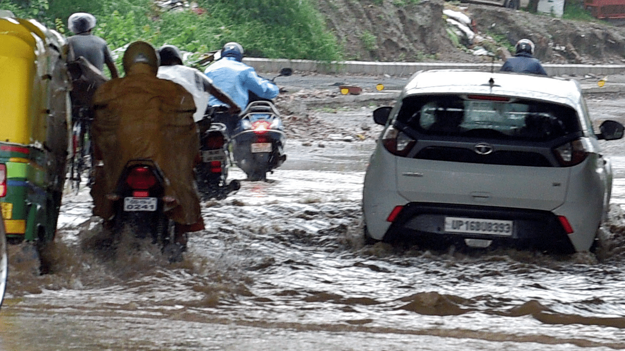 Traffic plie on a flooded road near Pragati Maidan, New Delhi. Credit: PTI Photo