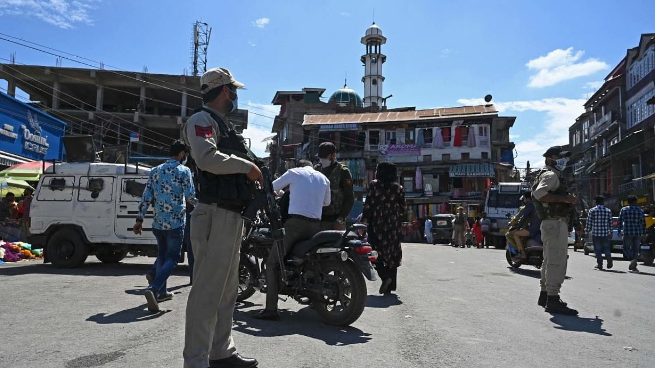 Policemen standing guard at a marker area in Srinagar on September 10, 2021. Credit: AFP Photo