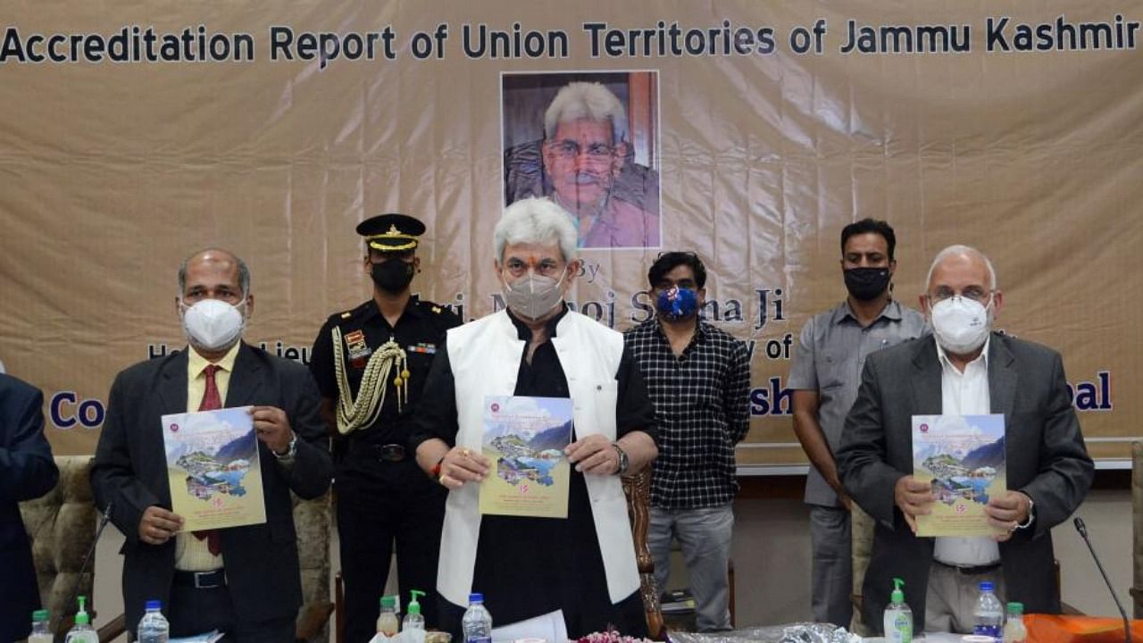 Jammu and Kashmir Lieutenant Governor Manoj Sinha along with Vice-Chancellor Central University of Kashmir Mehraj ud din Mir and other officials releases a book 'Analysis of Accreditation Report of Union Territories of Jammu Kashmir and Ladakh' during a function, at SKICC in Srinagar. Credit: PTI Photo