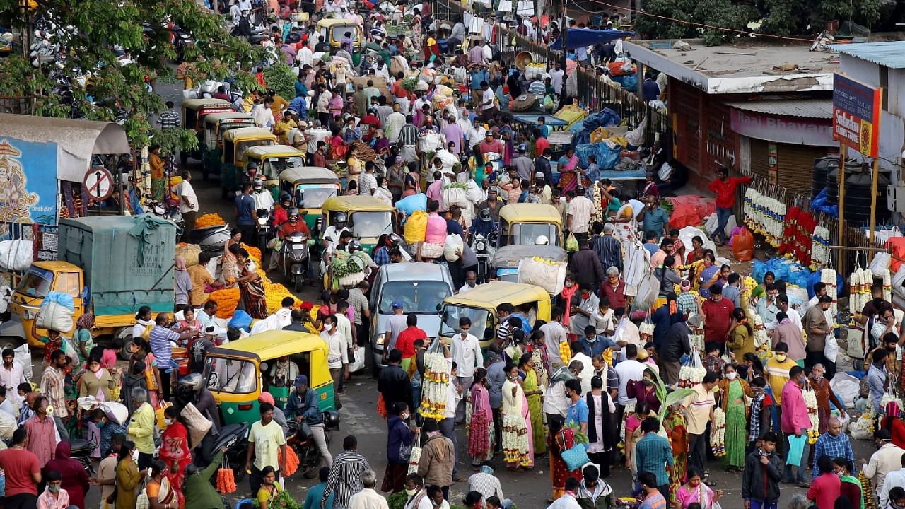 Large numbers of people gathered for shopping ahead of Ugadi festival at Krishnarajendra market, amid surge in Covid-19 cases across country in Bengaluru, Monday, April 12, 2021. Credit: PTI File Photo