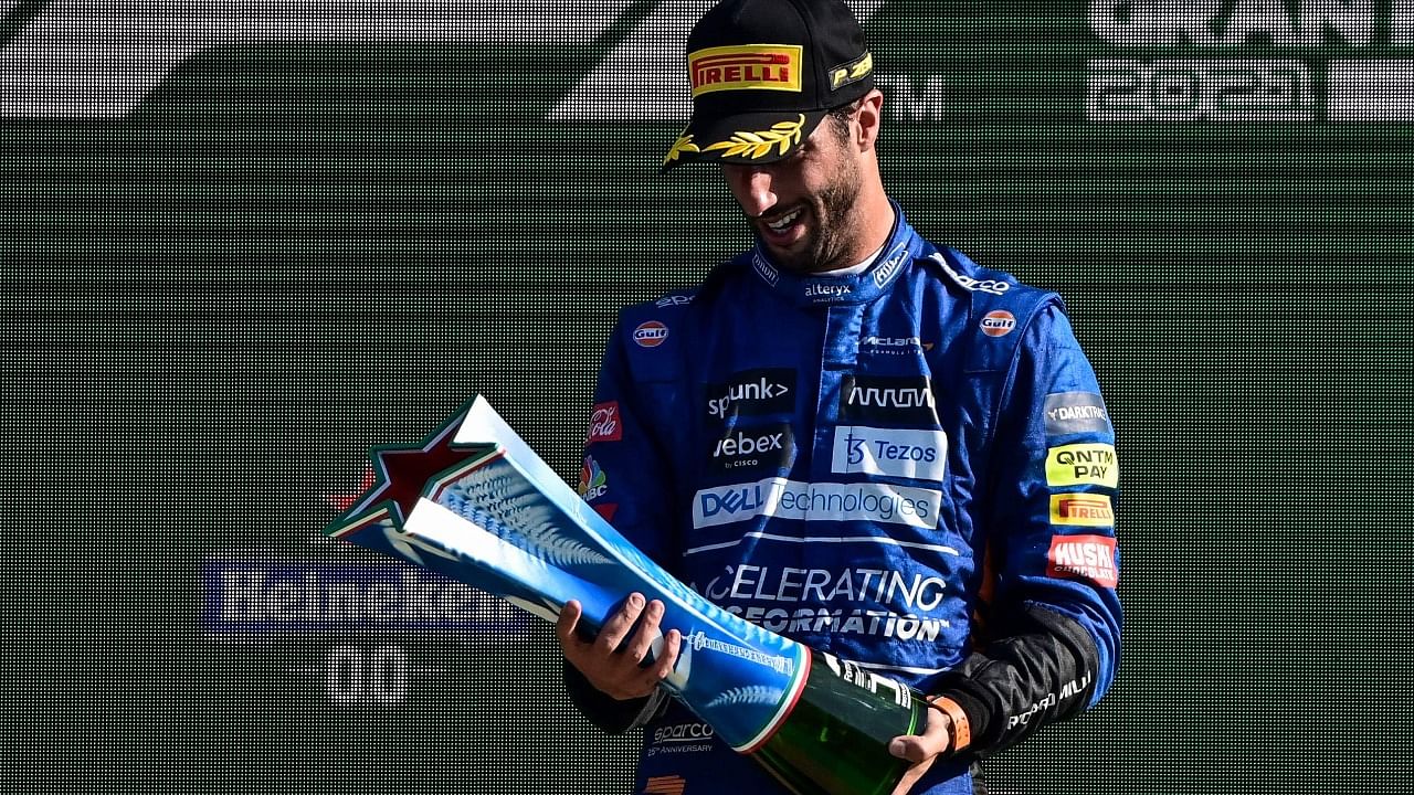 Daniel Ricciardo celebrates on the podium. Credit: AFP Photo
