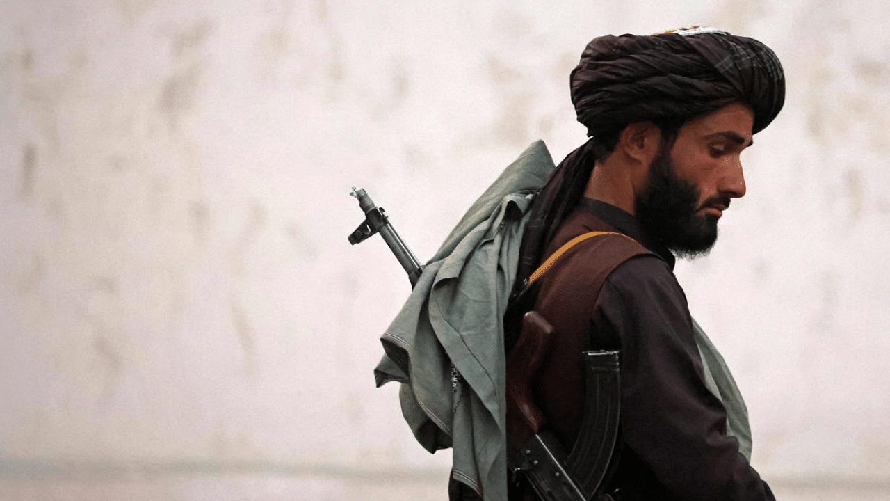 A Taliban fighter patrols along the airport in Kabul. Credit: AFP Photo