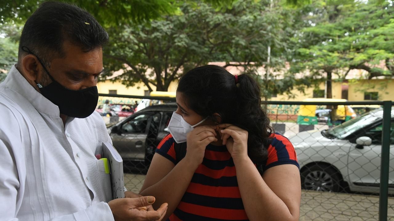 Student appearing for NEET exam in Bengaluru removes her earrings following the dress code. Credit: DH Photo/SK Dinesh