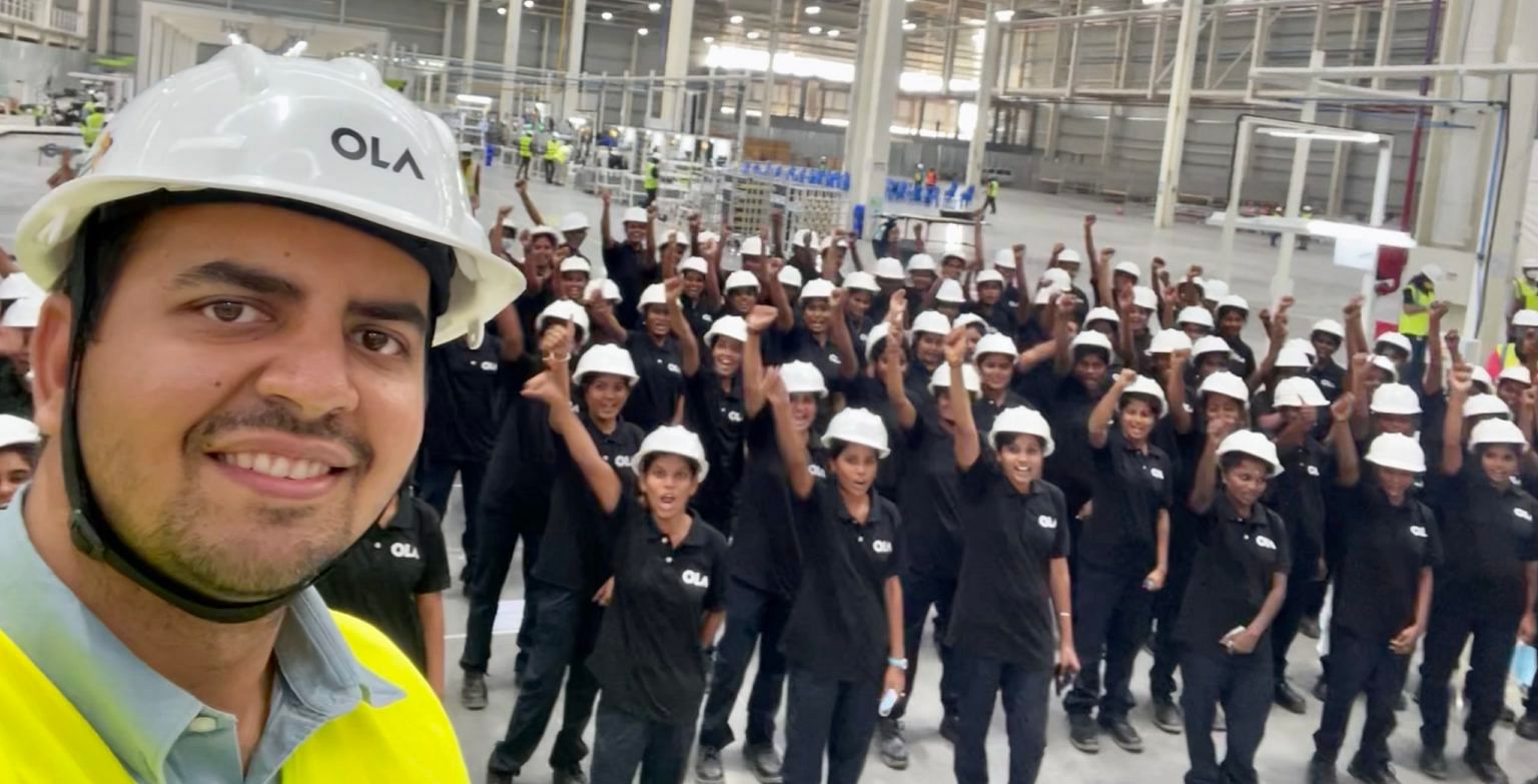 Ola Chairman and Group CEO Bhavish Aggarwal with factory workers. Credit: Ola Photo