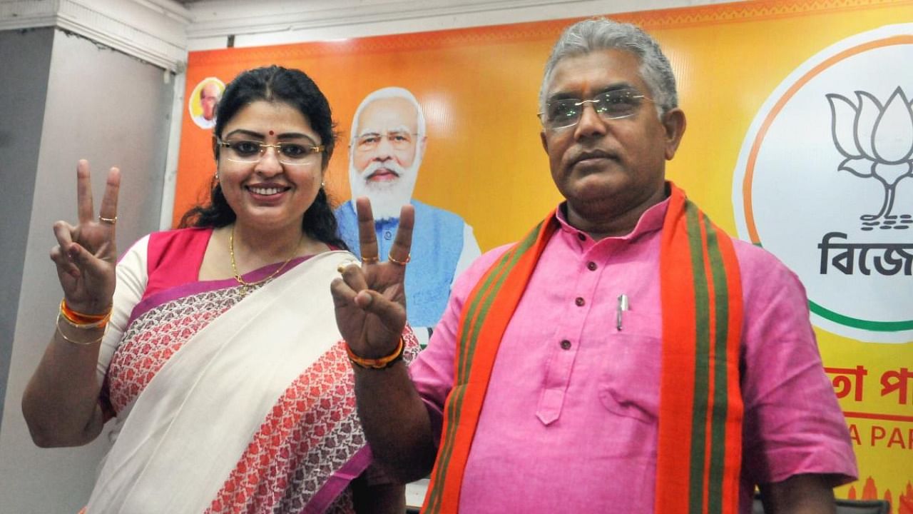 BJP's Priyanka Tibrewal with party's West Bengal President & MP Dilip Ghosh (R) flashes victory sign after the announcement of her name as the party candidate for Bhabanipur Assembly constituency bypoll. Credit: PTI Photo