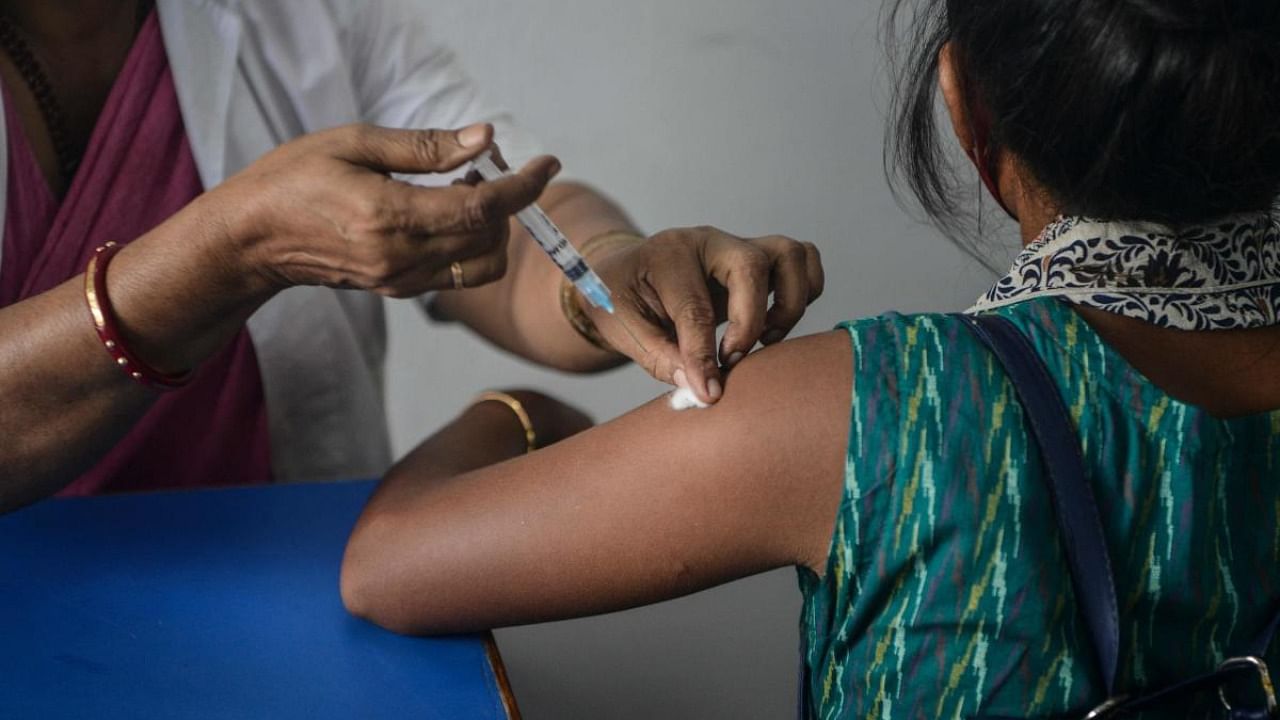 A health worker inoculates a student of Siliguri women's college with a dose of Covishield vaccine against the Covid-19 coronavirus at a vaccination camp in Siliguri. Credit: AFP Photo