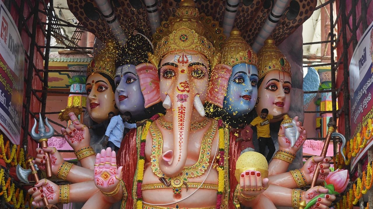 Devotees scatter flower petals on a 40-foot tall idol of the elephant-headed Hindu god Ganesha during the Ganesh Chaturthi festival in Hyderabad. Credit: AFP Photo