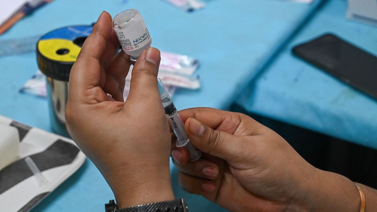 A health worker prepares a dose of Covaxin vaccine against Covid-19 coronavirus at a vaccination centre in New Delhi on September 14, 2021. Credit: AFP Photo
